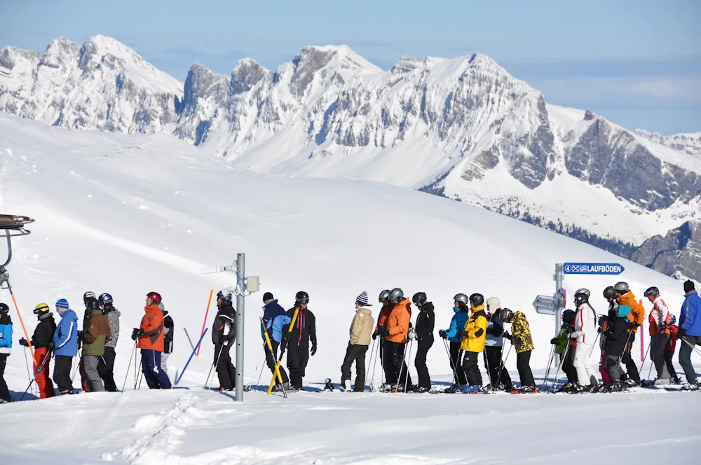 Skiers in queue for the lift